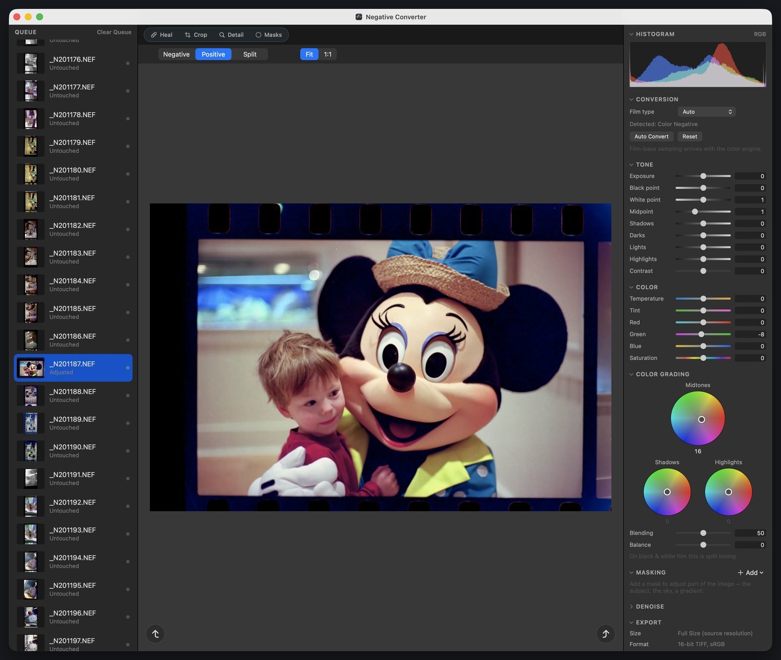 Negative Converter showing a strip of film with sprocket holes: a toddler beside a Minnie Mouse character from a forty-year-old family vacation, with tone, color, and color grading wheel controls open in the inspector